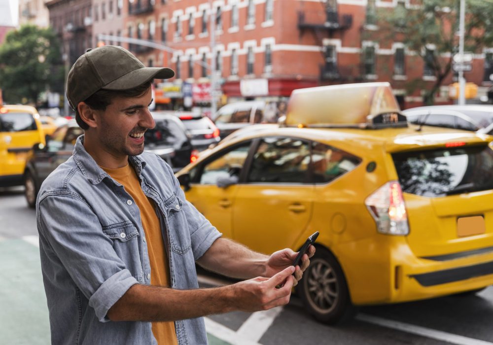 smiley-man-city-holding-mobile